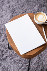 Obraz na płótnie Canvas blank magazine mockup on coffee table with cappuccino, pen and grey rug
