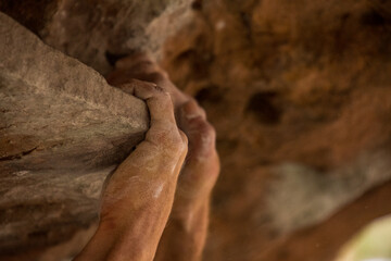 Hands of a climber climbing a roof