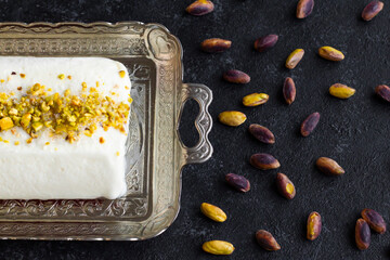 Traditional Turkish Maras Ice Cream, on a silver tray with cutlery and pistachios
