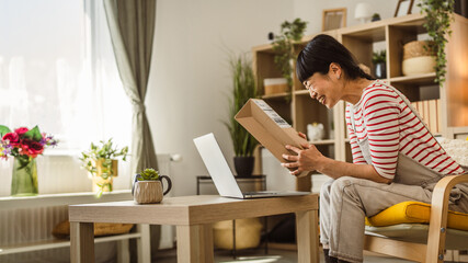 one japanese woman checking box of received package or product at home
