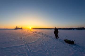 a man goes winter fishing in the north of Karelia