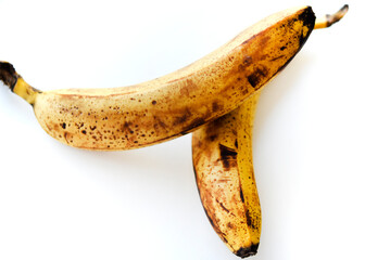 Overripe bananas on a white background. Ripe yellow fruit.