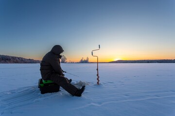 winter fishing in the north, frost at sunset