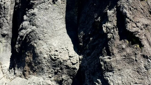 A rocky cliff with a grayish color. The cliff is an ancient volcanic core known as Rabbit Ears in Southern Oregon.