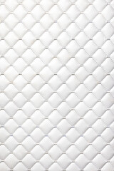 White furniture leather is stitched with quilted threads.