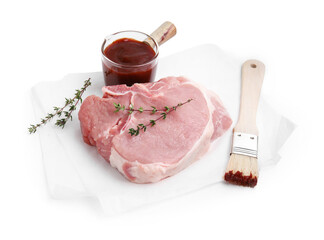 Raw meat, thyme, basting brush and marinade isolated on white