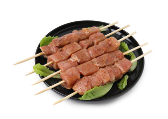 Wooden skewers with cut raw marinated meat isolated on white