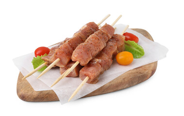 Wooden skewers with cut raw marinated meat isolated on white