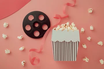 Foto op Plexiglas Elegant Movie-Themed Party Setup With Popcorn and Film Reel on Pink Background © Generative ART
