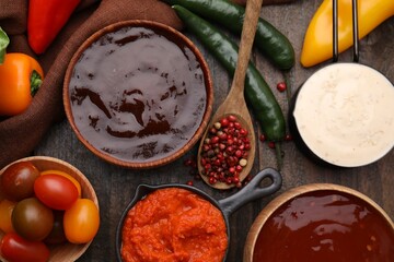 Different marinades and products on wooden table, flat lay
