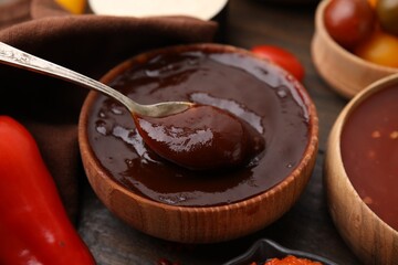 Taking homemade marinade from bowl at table, closeup