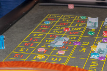 bets in the gambling game roulette: chips and paper money on the gaming table