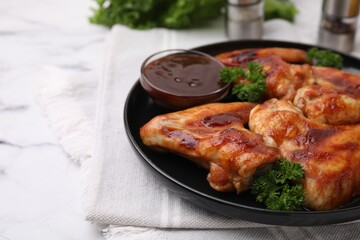 Fresh marinade and chicken wings on white table, closeup. Space for text