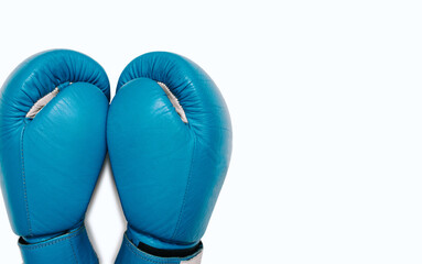 Blue boxing gloves isolated on white background with free space for text. A pair of blue leather...