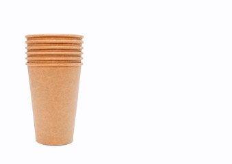 A stack of disposable coffee cups on a white background with free space for text. Cardboard cups which can be recycled. Disposable paper cups. Concept without waste, without plastic