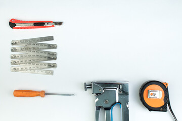 drill, putty knife, screwdrivers construction stapler on white background. Tool. Top view.