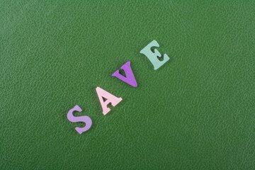 SAVE word on green background composed from colorful abc alphabet block wooden letters, copy space...