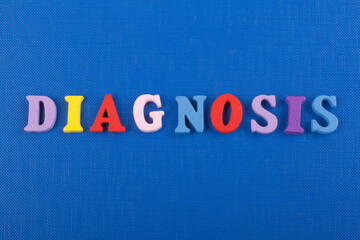 DIAGNOSIS word on blue background composed from colorful abc alphabet block wooden letters, copy space for ad text. Learning english concept.