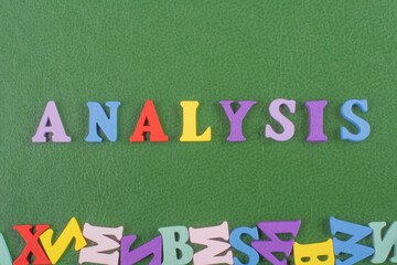 ANALYSIS word on green background composed from colorful abc alphabet block wooden letters, copy space for ad text. Learning english concept.