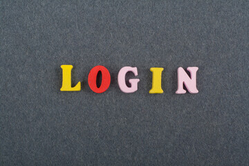 LOGIN word on black board background composed from colorful abc alphabet block wooden letters, copy space for ad text. Learning english concept.