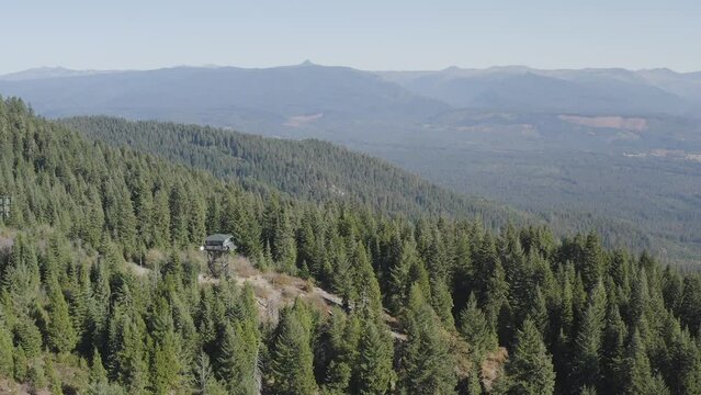 Fire lookout in the southern Oregon Cascades. The trees are green and the air is clear.