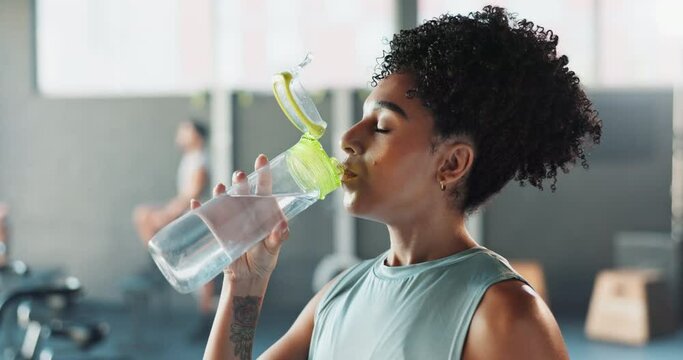 Gym, workout and water bottle for female athlete, studio and fitness and training. Woman, sports club and exercise for wellness and muscle, hydration and performance challenge in health facility