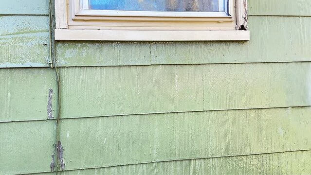 Power washing house siding close up