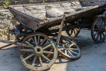 Old broken wooden carriage at the farm