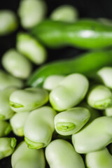 fresh greens broad beans fava on a dark background