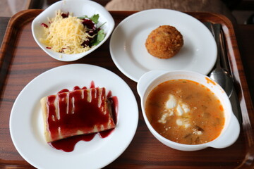 Table in a restaurant with a variety of
  snacks and food.