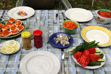 Table in a restaurant with a variety of
  snacks and food.
