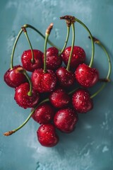 Ripe cherries on a vibrant blue background. Perfect for food and summer-themed designs