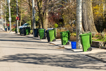 green economy:  compost bins waiting for collection on a residential street shot in spring in tthe...