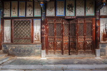 Richly decorated facade at the courtyard of a historic house in the ancient town of Tuanshan,...