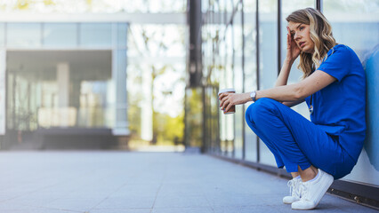 Sometimes not everything is in our hands. Shot of a female nurse looking stressed while sitting outdoors of the hospital. Sad or crying female nurse. 