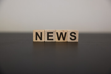 Wooden news sign on a table in an office