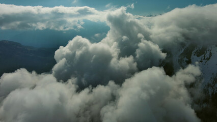 Flying through clouds between mountains - 786589025