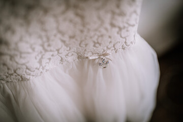 Valmiera, Latvia- July 28, 2024 - A close-up of a white bridal dress with lace detailing and a...