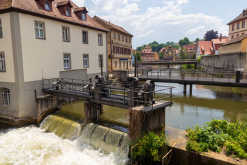 Panorama with bridge and weir at river Regnitz and half-timbered houses in Bamberg, Upper Franconia, Bavaria, Germany
