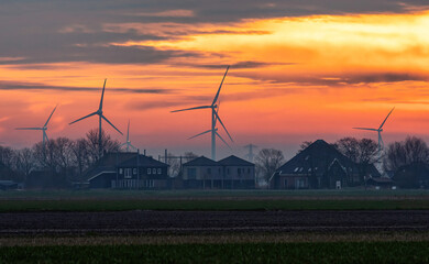 Wind turbines in the Netherlands, countryside in the morning.