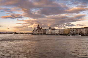 Fototapeta premium Amazing hungarian parliament building on the shore of Danube river in the city of Budapest, Hungary at sunset