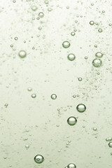 Bubbles in water on a green background. Shallow depth of field.