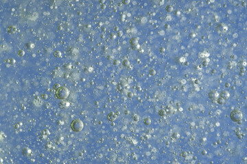 Fototapeta premium Bubbles in the water on a blue background. Closeup.