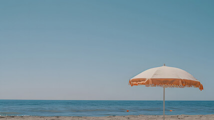 Minimal summer holidays vacation concept. Beach umbrella in front of blue sky and sea. Chilling, lounging on the beach
