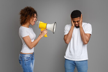 African-american girl shouting through megaphone at her boyfriend
