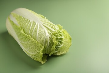 Fresh ripe Chinese cabbage on pale green background. Space for text