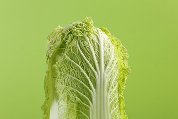 Fresh ripe Chinese cabbage on light green background, closeup - obrazy, fototapety, plakaty