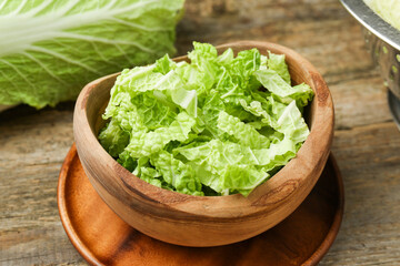 Cut fresh Chinese cabbage on wooden table, closeup - obrazy, fototapety, plakaty