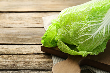 Fresh ripe Chinese cabbage on wooden table, closeup. Space for text