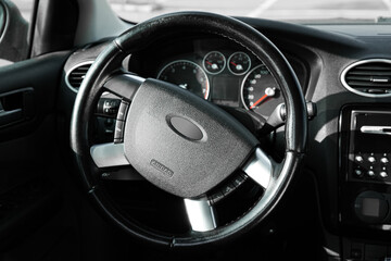 Black steering wheel and dashboard in car